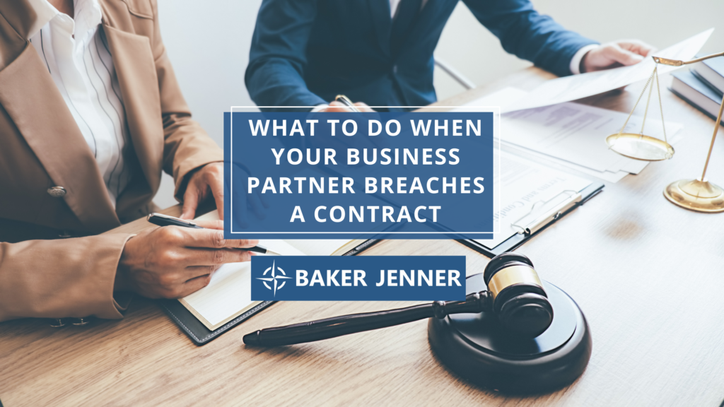 Two people in business attire sit at a desk reviewing documents with a gavel and scales of justice nearby. Text reads: What to do when your business partner breaches a contract. Baker Jenner.