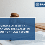 A judges gavel rests on a desk with papers, overlaid by text about Georgia’s tort law reform. The Baker Jenner logo appears in the top right corner. The word BLOG is arranged in a curve on the left side.