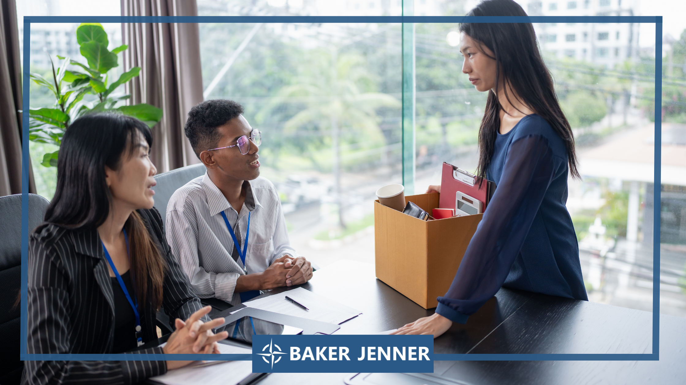 A woman stands holding a box of personal items while two people sit across a desk from her, appearing to speak with her in an office setting. The scene is branded with the Baker Jenner logo.